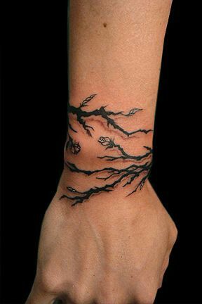 Black Tree Branches Wristband Tattoo On Upper Wrist
