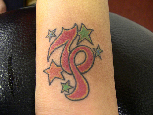 Colored Stars And Girly Capricorn Tattoo On Forearm