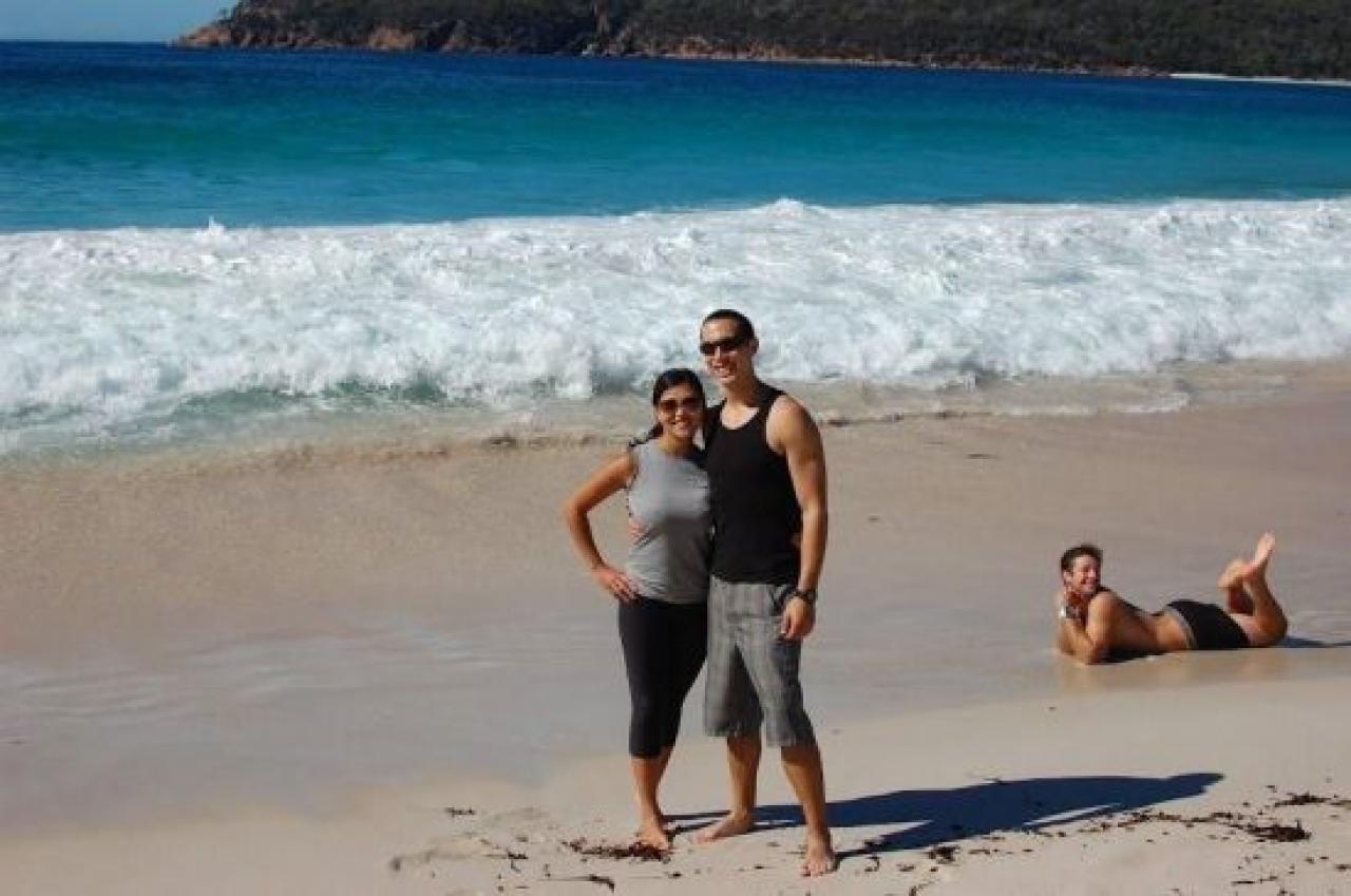 Man Behind Couple Funny Photoshoot On Beach