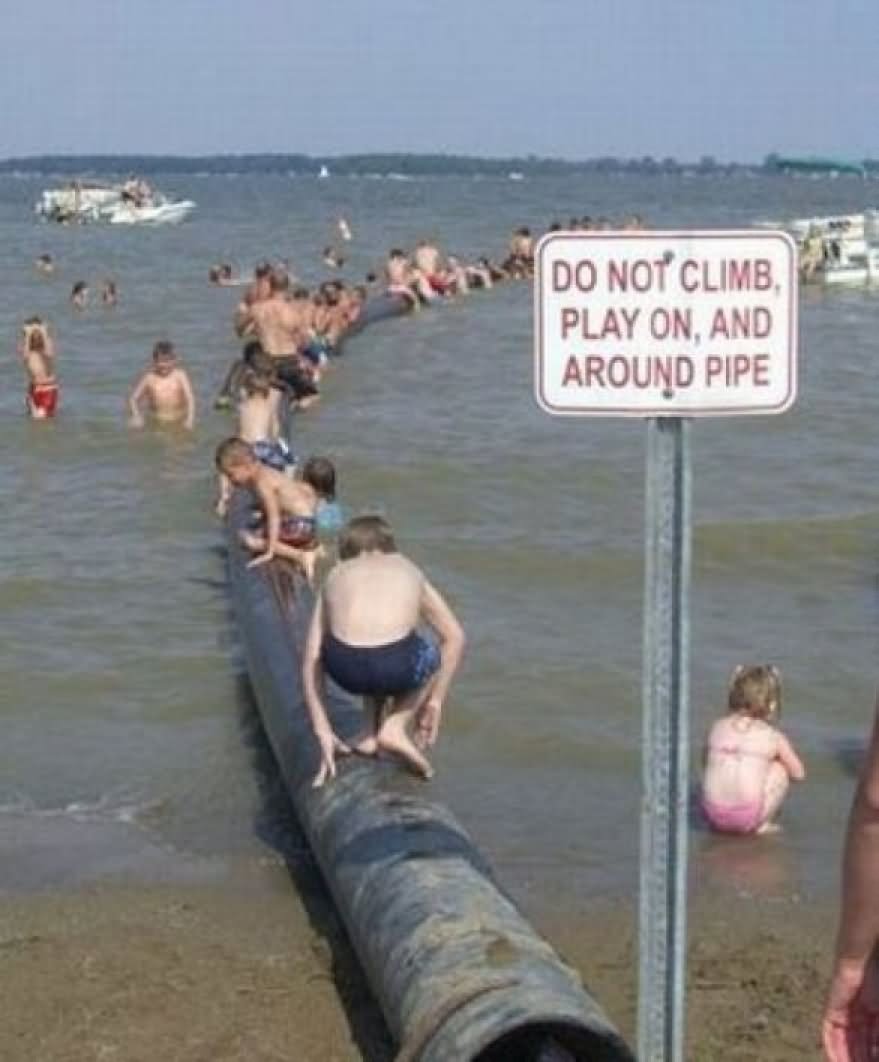 Do Not Climb Play On And Around Pipe Funny Warning Sign Board On Beach