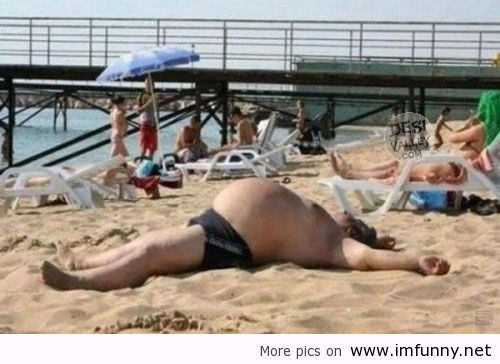 Funny Fat Man Sleeping On Beach