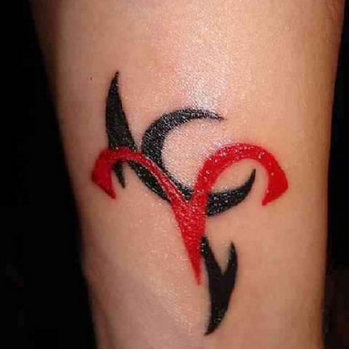 Red And Black Ink Capricorn Tattoo On Forearm