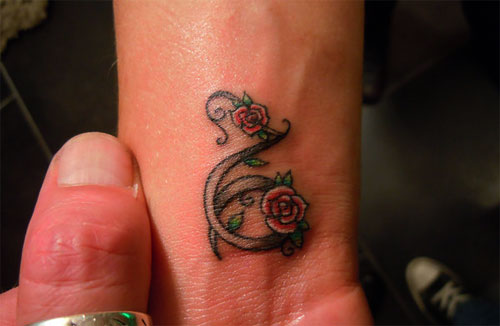 Red Rose Flowers And Girly Capricorn Tattoo On Wrist