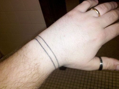 Simple Black Two Line Wristband Tattoo On Upper Wrist