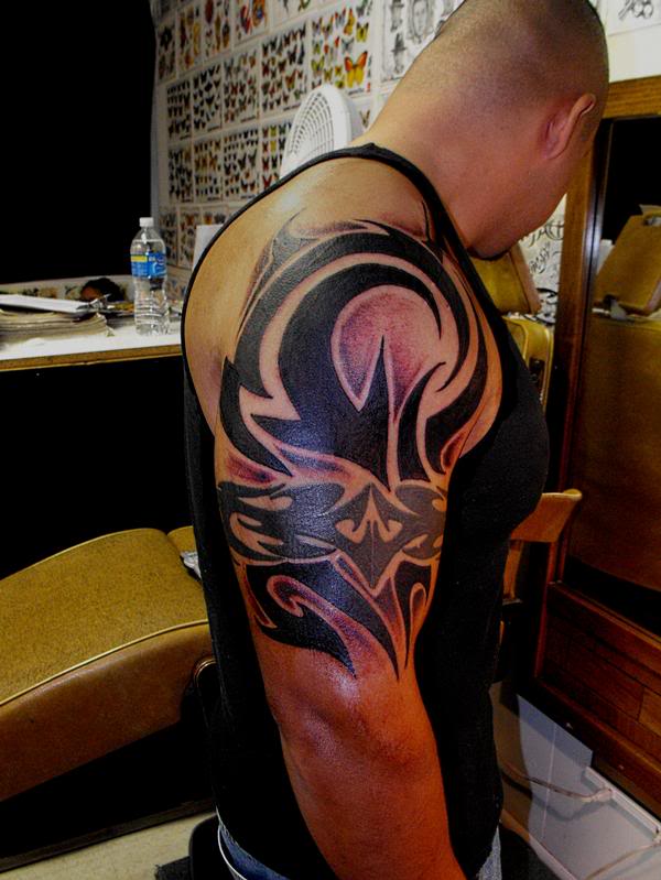 Tribal Capricorn Tattoo On Right Half Sleeve For Men