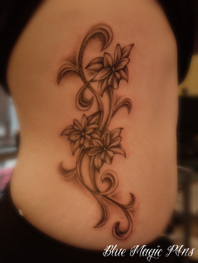Amazing Black Ink Flowers Tattoo On Side Belly