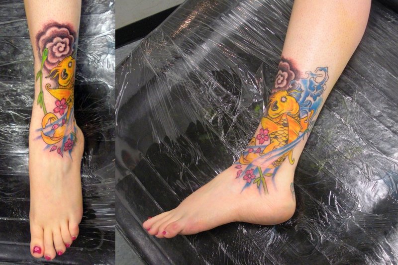 Aqua Color Koi Fish With Flowers Tattoo On Girl Leg