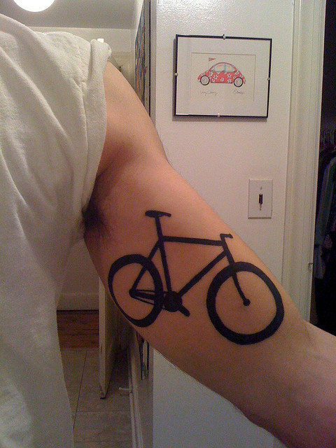 Awesome Black Bike Tattoo On Bicep