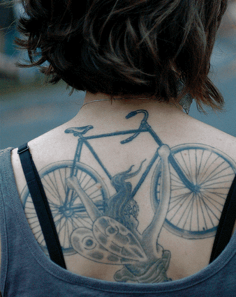 Black And Grey Fairy With Bike Tattoo On Upper Back