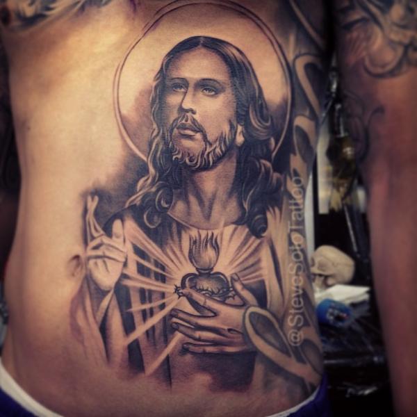 Black And Grey Jesus Face Tattoo On Side Belly