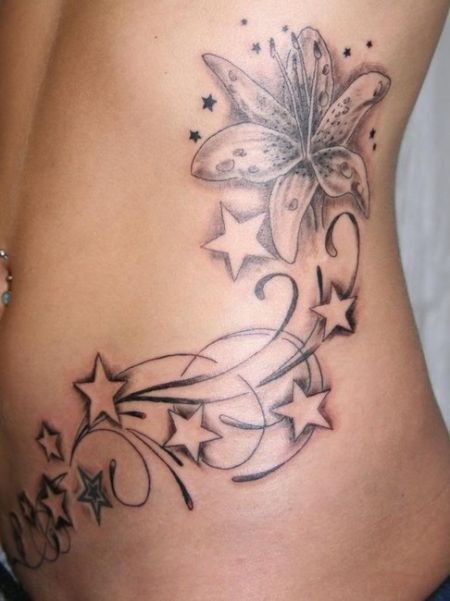 Black And Grey Lily Flower With Stars Tattoo On Side Belly