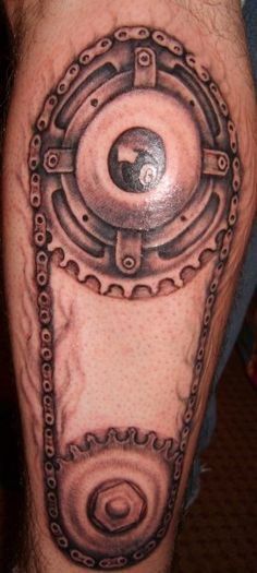 Black And Grey Two Gears Tattoo On Leg