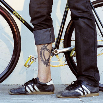 Black Bike Half Gear Tattoo On Leg Calf