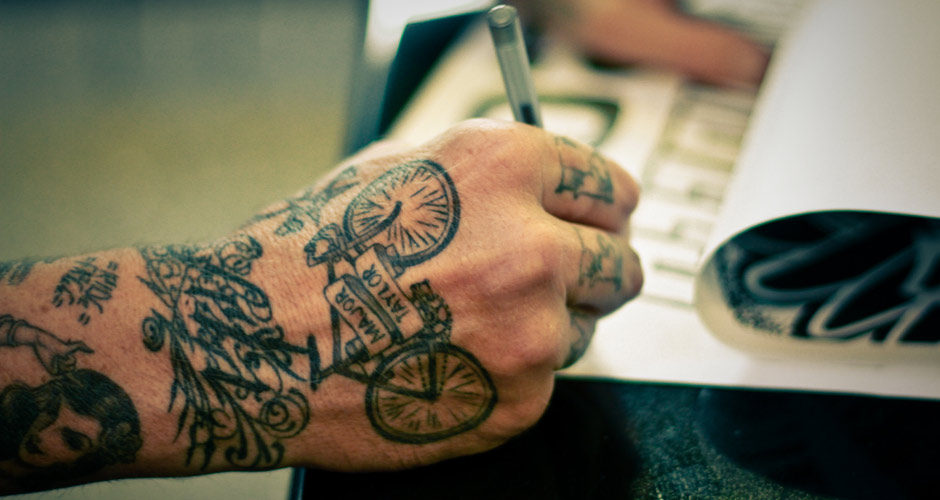 Black Bike With Banner Tattoo On Hand