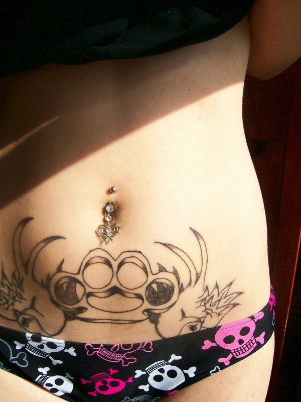 Black Brass Knuckle Tattoo On After Pregnancy Belly
