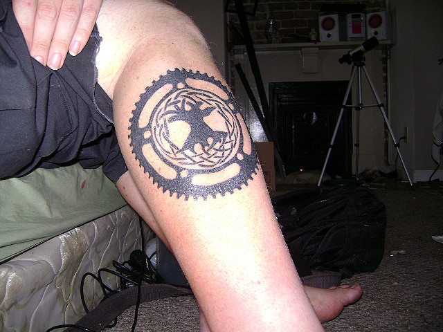 Black Celtic Bike Gear Tattoo On Leg Calf