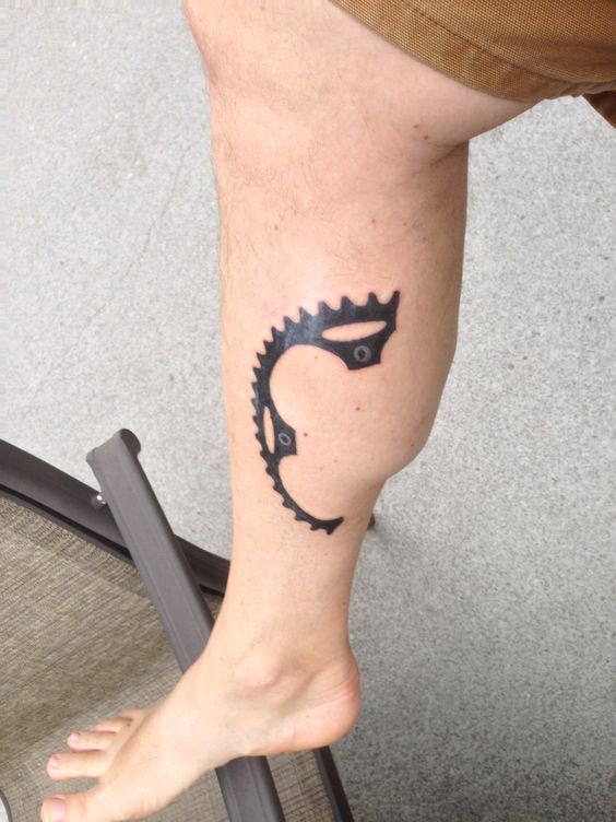 Black Half Bike Gear Tattoo On Leg Calf