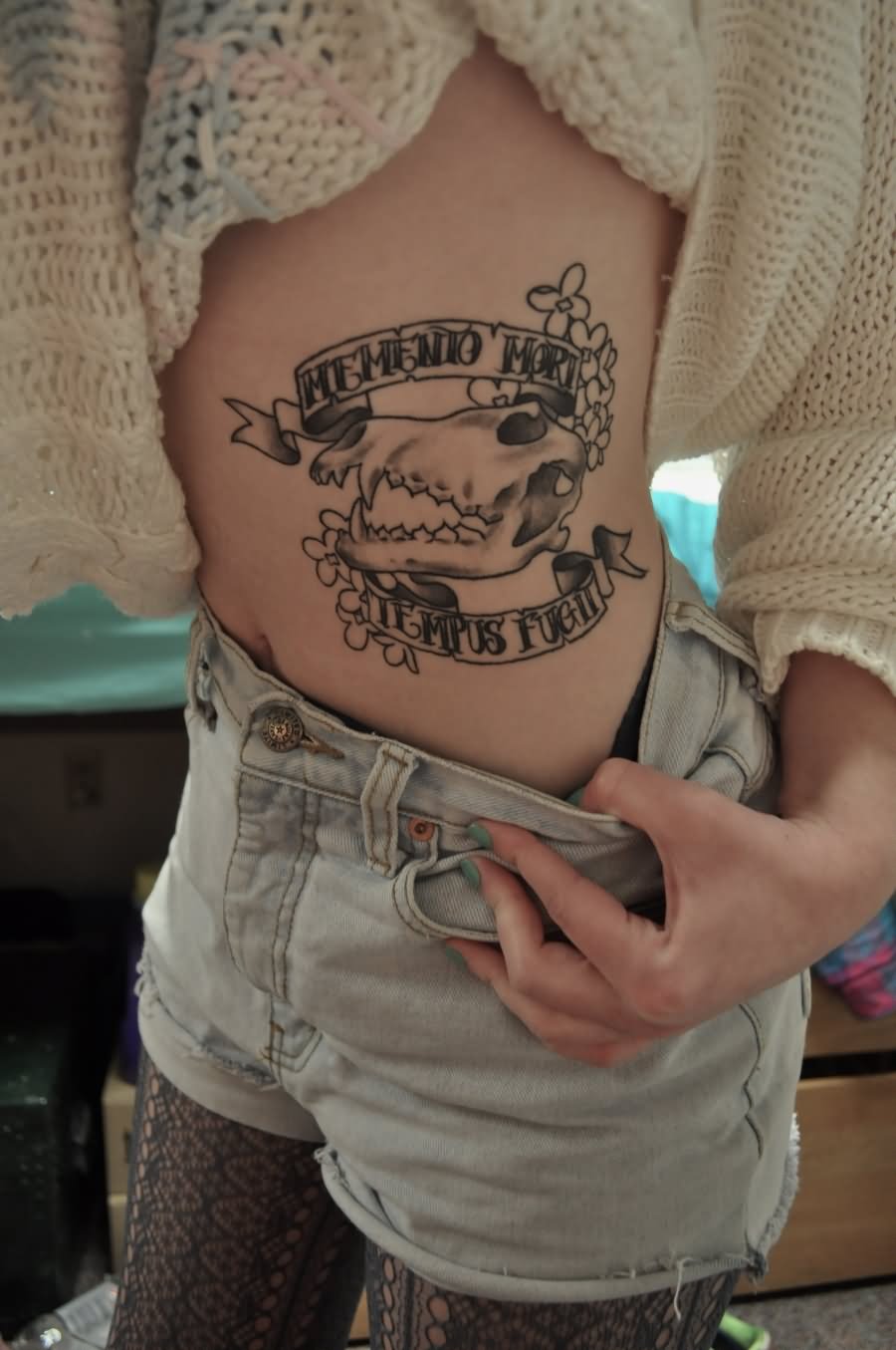 Black Ink Cow Skull With Banner And Flowers Tattoo On Girl Side Rib