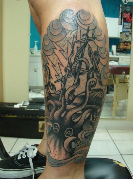 Black Ink Kraken Attacking Ship Tattoo On Leg