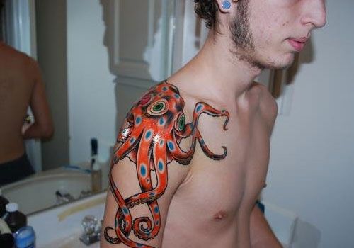 Blue Dotted Orange Octopus Tattoo On Shoulder
