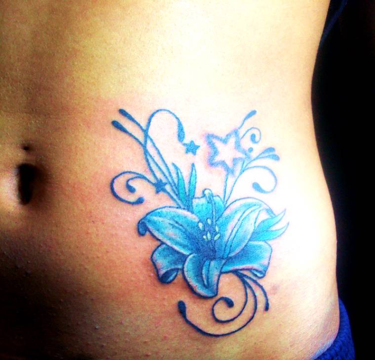 Blue Ink Flower Tattoo On Side Belly