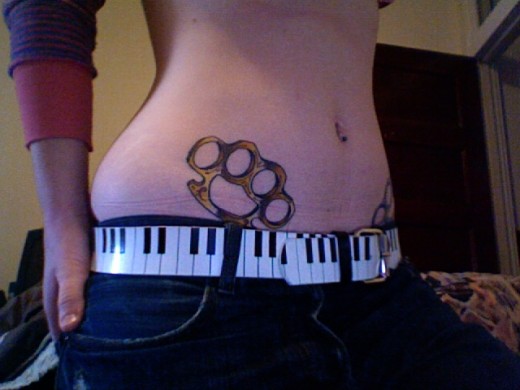 Brass Knuckle Tattoo On Belly