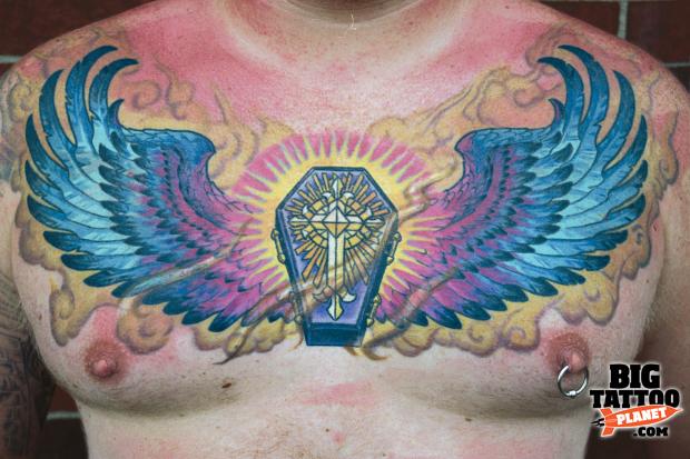 Colored Winged Coffin Tattoo On Man Chest