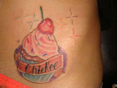 Colorful Cupcake With Banner Tattoo Design For Side Belly