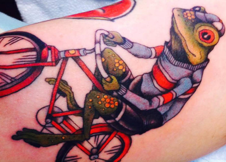 Colorful Frog Riding Bike Tattoo Design
