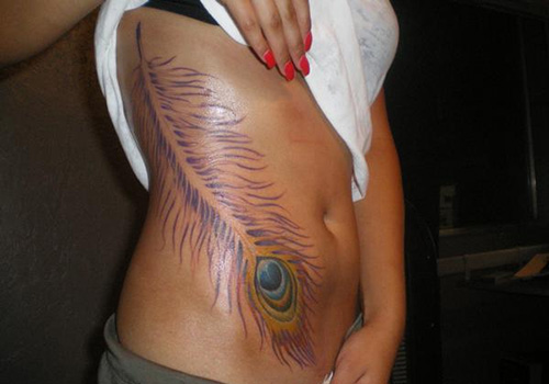 Colorful Peacock Feather Tattoo On Girl Side Belly