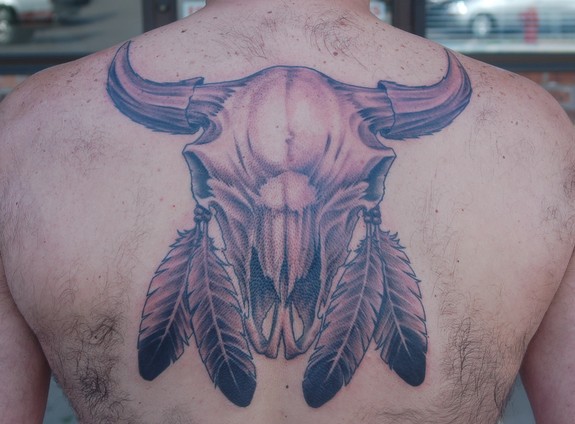 Cow Skull With Feathers Tattoo On Man Upper Back