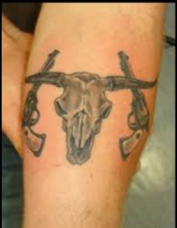 Cow Skull With Two Guns Tattoo On Forearm
