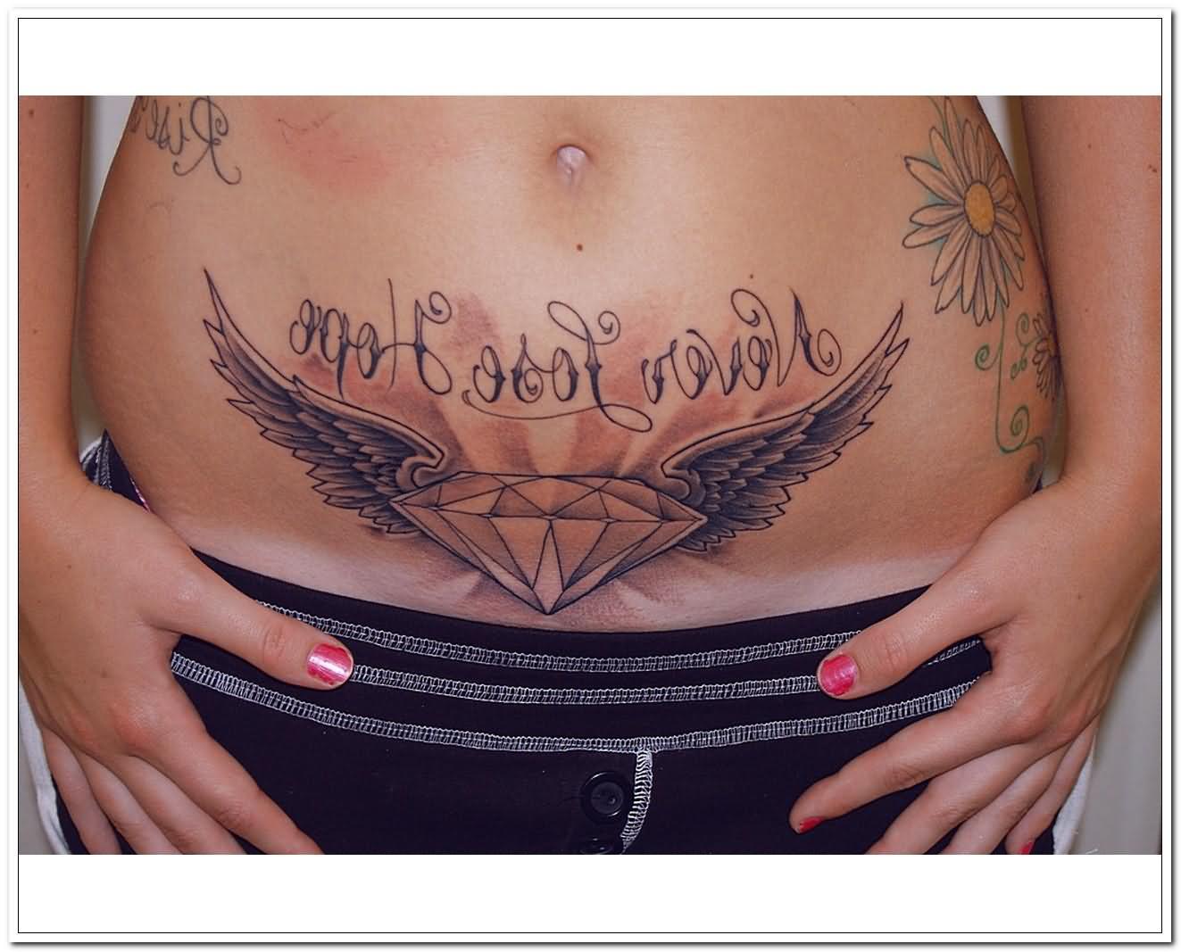 Diamond With Wings Tattoo On After Pregnancy Belly