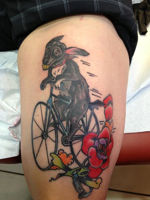 Dog Riding Bike With Flower Tattoo Design