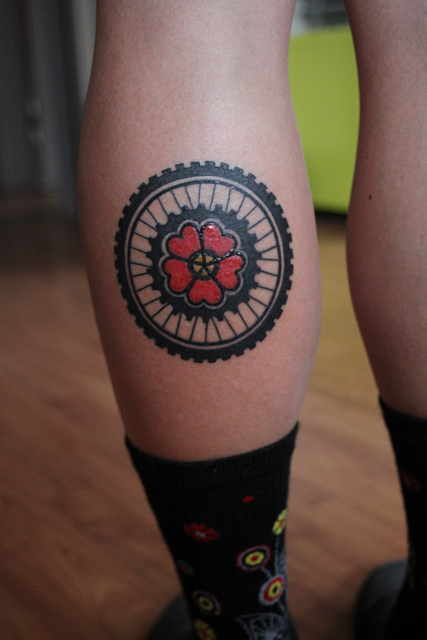 Flower In Bike Wheel Tattoo On Leg Calf