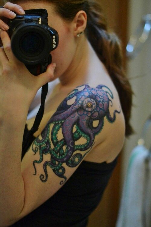 Girl Showing Her Octopus Tattoo On Left Shoulder