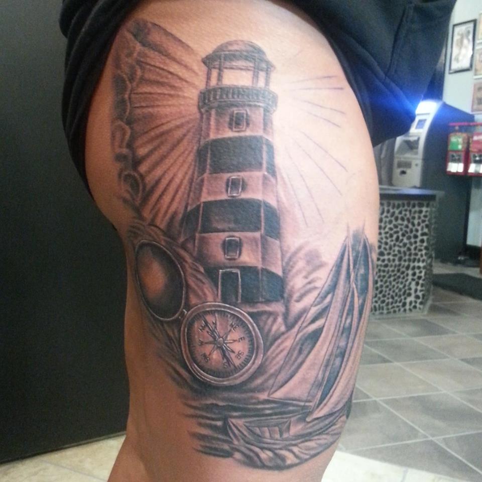 Grey Compass And Lighthouse Tattoo On Thigh
