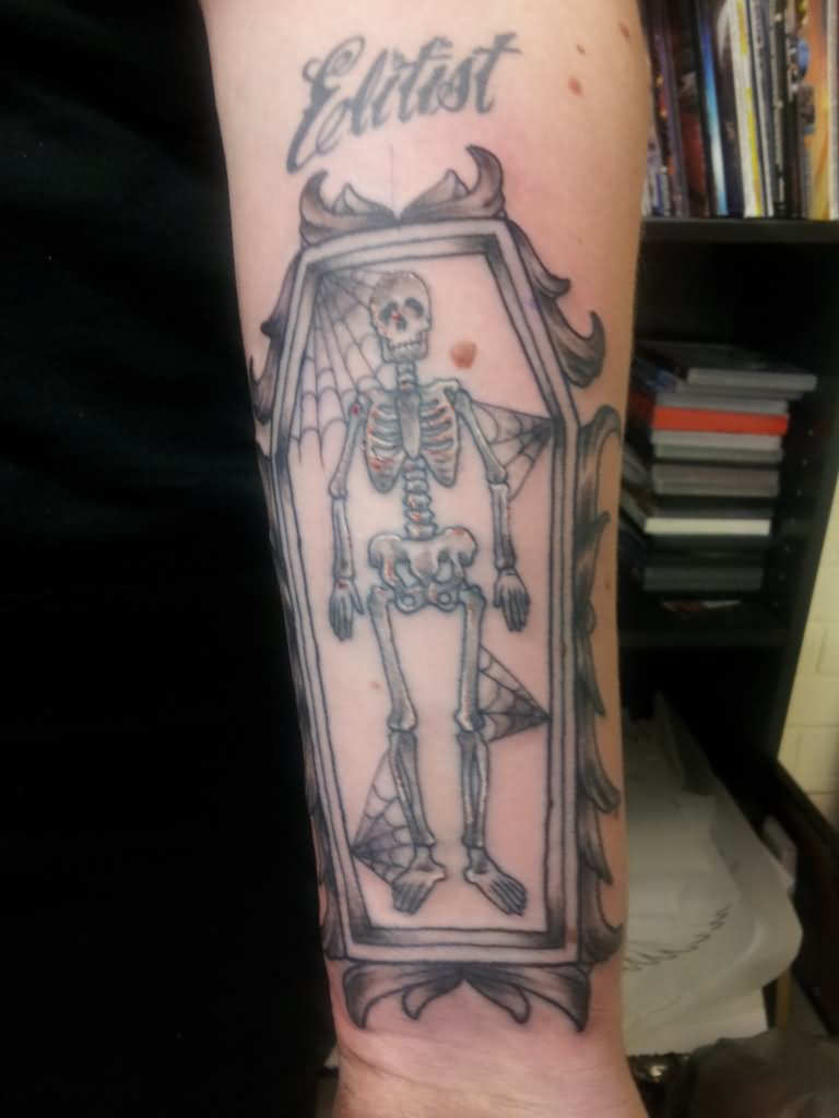 Grey Ink Coffin Skeleton Tattoo On Forearm