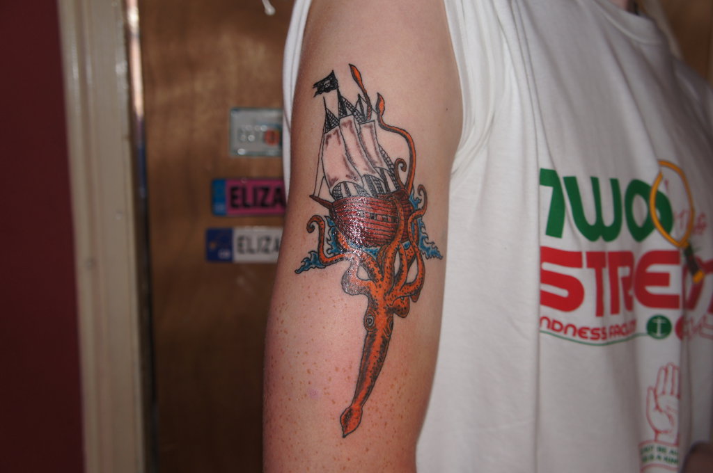 Kraken Pulling Ship Tattoo On Right Half Sleeve