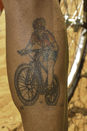 Man Riding Mountain Bike Tattoo Design For Leg Calf