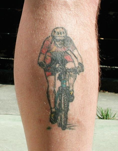Man Riding Mountain Bike Tattoo On Leg