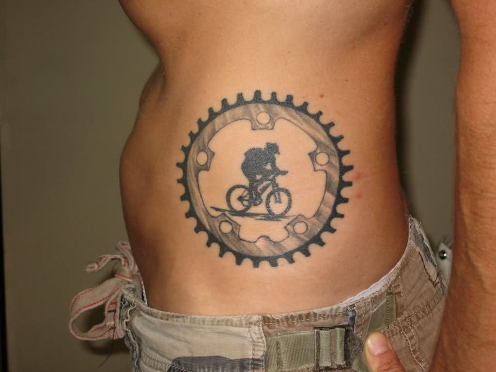 Man Riding Mountain Bike Tattoo On Side Rib