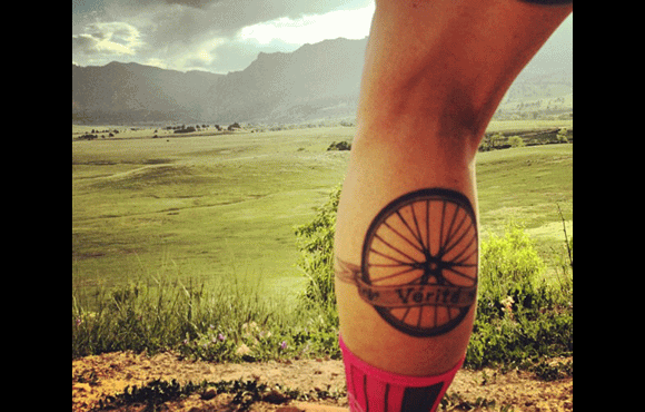 Mountain Bike Wheel With Banner Tattoo On Leg Calf
