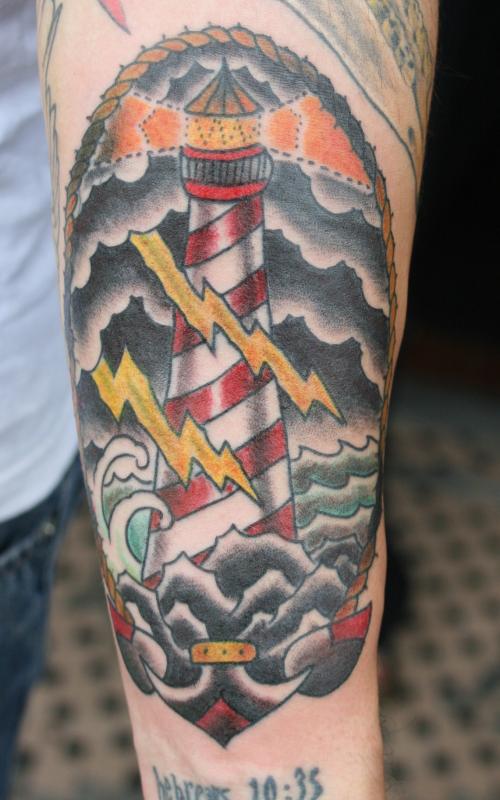 Nice Colored Anchor And Lighthouse Tattoo On Left Forearm
