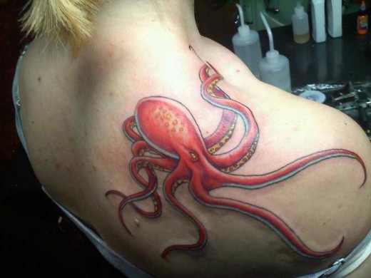 Red Ink Octopus Tattoo On Girl Right Back Shoulder