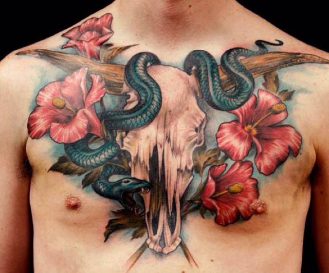Traditional Cow Skull With Snake And Flowers Tattoo On Man Chest
