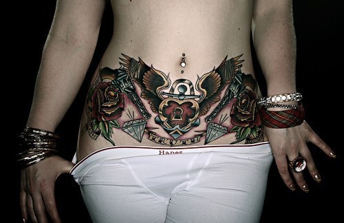 Traditional Heart Lock With Wings And Flower Tattoo On Belly