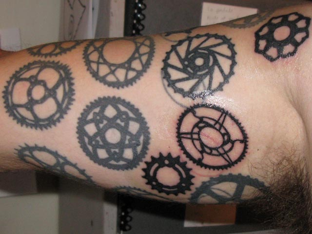 Unique Black Bike Gears Tattoo On Half Sleeve