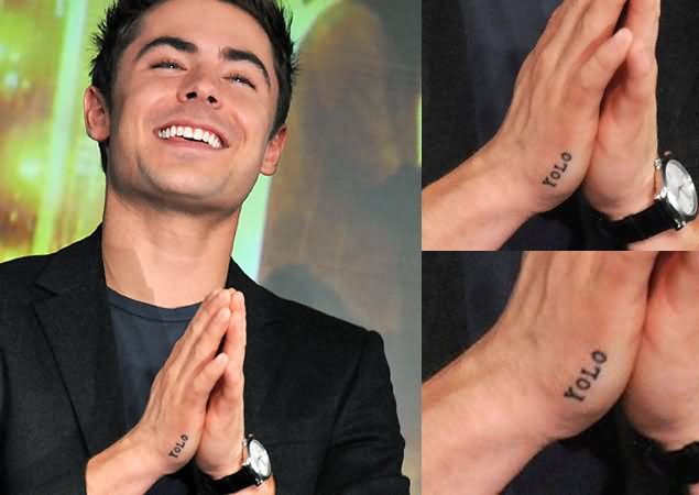 Yolo Lettering Tattoo On Celebrity Zac Efron Hand.
