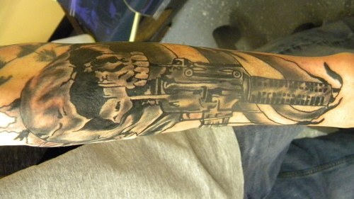 Army Skull With Gun Tattoo On Forearm